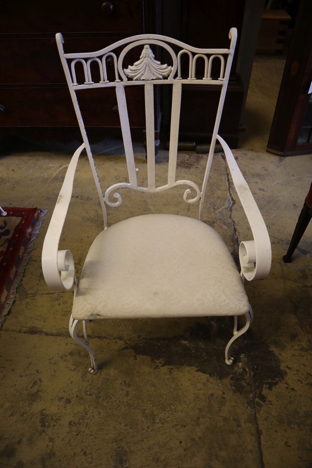 A French cast and wrought iron circular glass top garden table and four chairs, table diameter 136cm